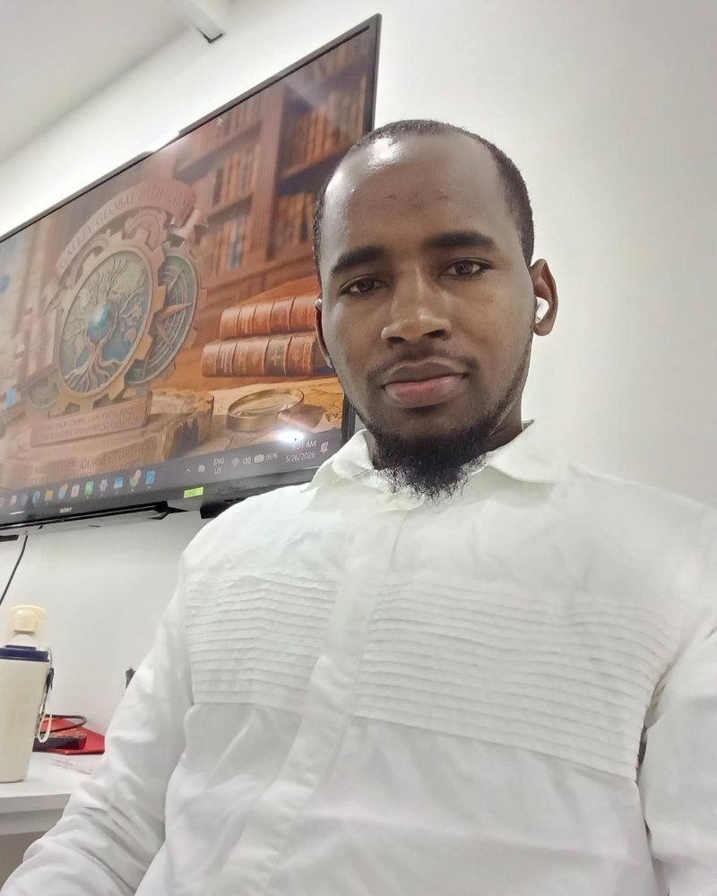 Mohamed Boye Bah in a white shirt, with the Galley Global Pathways emblem on the screen behind him